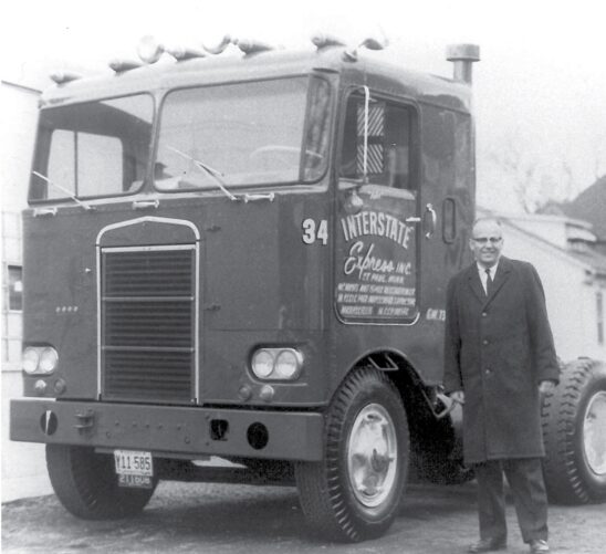 picture of Hugh Schilling in front of a semi-truck with its first installation of the fan clutch